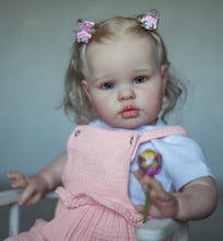 Load image into Gallery viewer, 24inch Reborn Baby Girl Ellie - Blonde Rooted Hair in Pigtails & Blue Eyes, Pink Sheer Overalls with White Onesie, Plush Body & Butterfly Pacifier