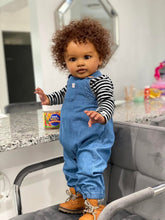 Cargar imagen en el visor de la galería, 26&quot; Deep Skin Baby Doll with Implanted Brown Afro &amp; 3D Eyes - Denim Overalls w/ Black-White Striped Lining - Realistic Pippa
