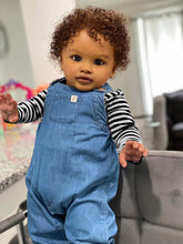 Cargar imagen en el visor de la galería, 26&quot; Deep Skin Baby Doll with Implanted Brown Afro &amp; 3D Eyes - Denim Overalls w/ Black-White Striped Lining - Realistic Pippa
