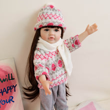 Load image into Gallery viewer, 55cm Reborn Baby Girl Doll &quot;Betty&quot; with Long Brown Hair, Blue Eyes, Full Vinyl Body | Wearing Flower Sweater + White Sneakers
