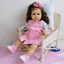 Cargar imagen en el visor de la galería, 24&quot; African American Baby Doll Ellie - Rooted Long Brown Curls &amp; Chocolate Eyes | Pink Overalls with Floral Lining | Ultra-Soft Cloth Body
