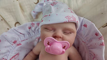 Load and play video in Gallery viewer, PINKY REBORN Peaches | 12-Inch Solid Silicone Reborn Baby Girl Doll | Ultra-Realistic Sleeping Newborn with Pink Swaddle Blanket | Premium Collector's Doll
